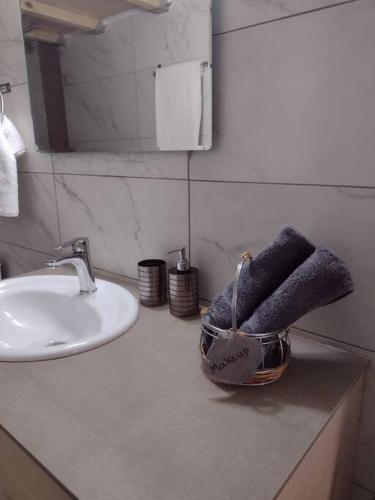 a bathroom counter with a sink and a towel at Snowbird-late check-out in Ierapetra
