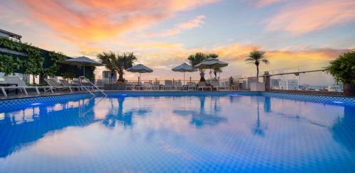 a large swimming pool on top of a building at Eden Star Saigon Hotel in Ho Chi Minh City