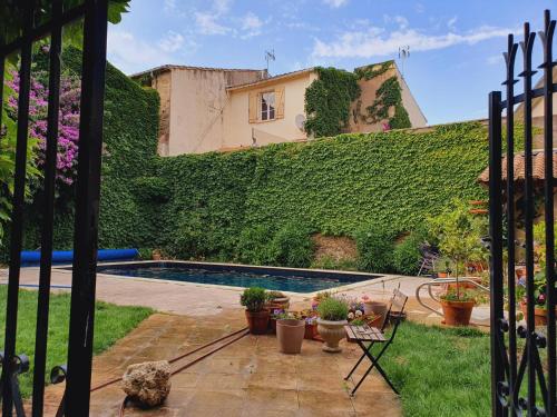 a garden with a swimming pool and a building at Luxurious Character House in the Heart of Roujan in Roujan