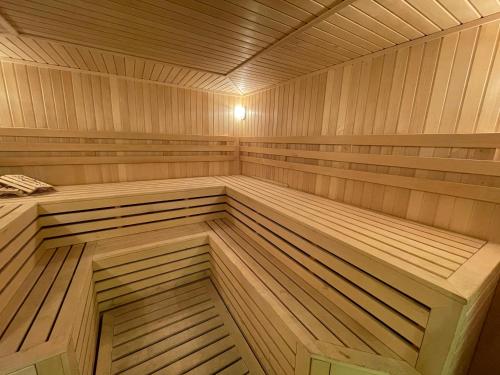 a large wooden sauna with wooden floors at Chinor Hotel Fergana in Fergana