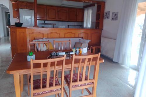 a kitchen with a wooden table and chairs at Stamatia's Houses in Agios Georgios
