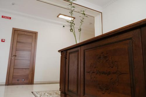 a wooden cabinet with a vase on top of it in a room at Готель Хутір in Malyye Khutora