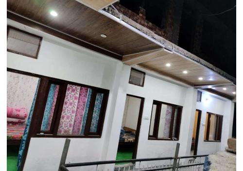 a row of windows on a white building at Hotel Prakriti in Gangotri