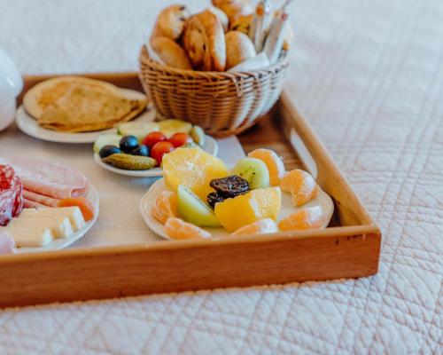 a tray filled with different types of food on a table at Hotel Le Grimaldi by Happyculture in Nice
