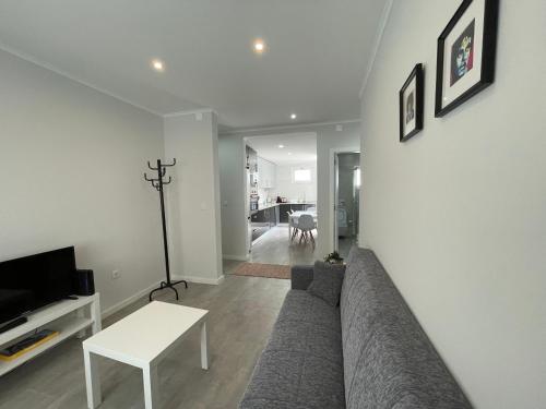 a living room with a couch and a table at Happy House Barreiro in Barreiro