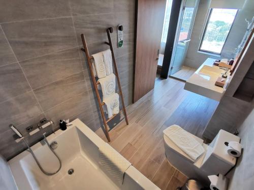 a bathroom with a toilet and a sink at Centara Korat in Nakhon Ratchasima