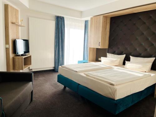 a bedroom with a large bed and a tv at Modernes Apartment mit Blick zur Frauenkirche in Dresden