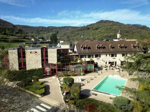 a resort with a swimming pool and a building at Logis Auberge La Diege in Capdenac-Gare