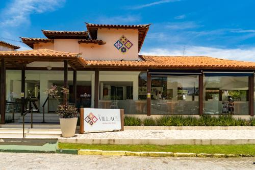 a building with a sign in front of it at Le Village Boutique Hotel in Búzios