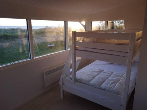 a bunk bed in a room with a window at Sjöstugor med SPA i Höllviken in Höllviken