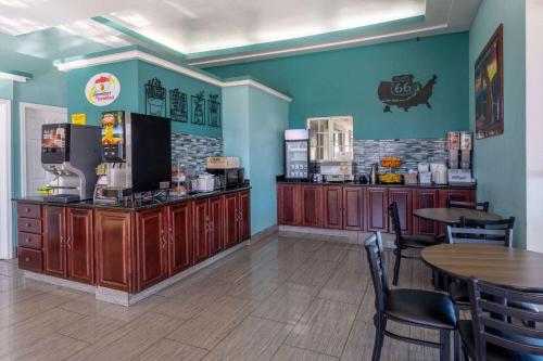 a restaurant with tables and chairs and a coffee shop at Super 8 by Wyndham NAU/Downtown Conference Center in Flagstaff