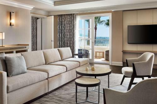 a living room with a couch and a tv at Park Hyatt Aviara in Carlsbad
