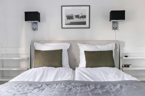 a bedroom with a bed with two pillows at Hotel Malmkoping, BW Signature Collection in Malmköping