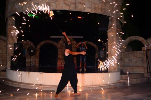 a man is dancing on a stage with a pole at MIRAMOR HOTEL & Spa - ULTRA ALL INCLUSIVE SELECTION in Kemer