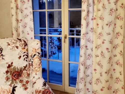 a couch sitting in front of a window at Provence Bystrá - Chopok & wellness 2 in Bystrá