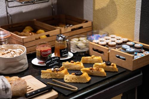 a table with a bunch of pastries and other foods at Catalonia Roma in Barcelona