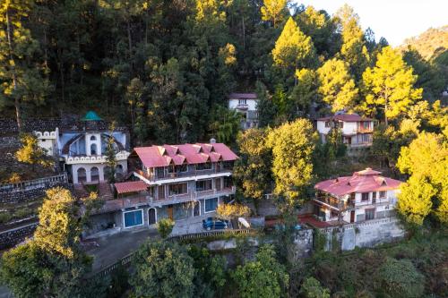 an aerial view of a mansion in a forest at The Canadian Woods Resort in Nainital