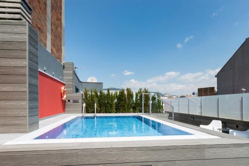 a swimming pool on the side of a building at Catalonia Roma in Barcelona
