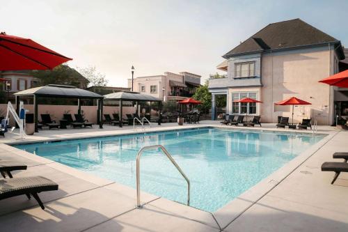 a large swimming pool with chairs and umbrellas at Gateway Hotel, Trademark Collection by Wyndham in Copper Cove Subdivision