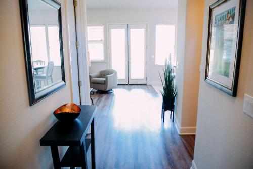 a living room with a table and a chair at Gateway Hotel, Trademark Collection by Wyndham in Copper Cove Subdivision