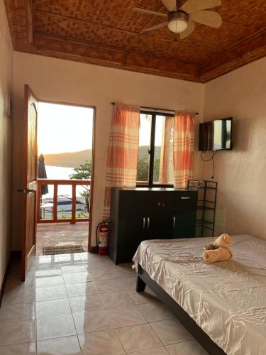 a bedroom with a teddy bear laying on a bed at Virly’z Top View Resort in Tudela