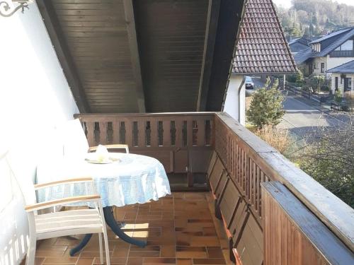 a patio with a table and chairs on a balcony at Ferienwohnung Am Rehwinkel in Fuldatal
