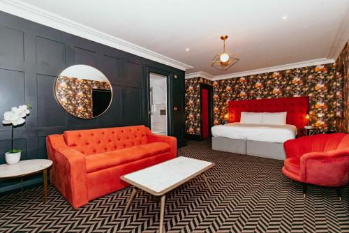 a bedroom with a bed and red furniture and a mirror at Lock and Key Boutique Hotel - Duke Street in Liverpool