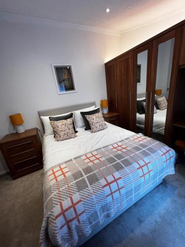 a bedroom with a large bed and a mirror at Lowena Lodge in Troutbeck