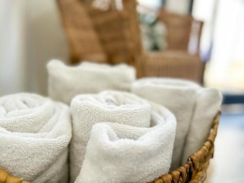 a group of white towels in a basket at Gilboa cliffs- boutique suite in Nurit