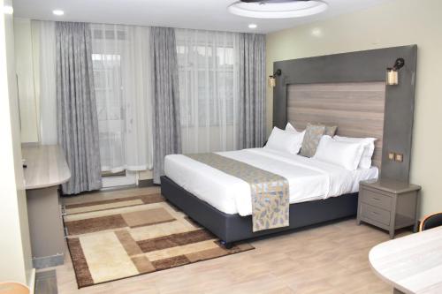 a bedroom with a large bed in a room at Dallas Premiere Hotel in Kisii