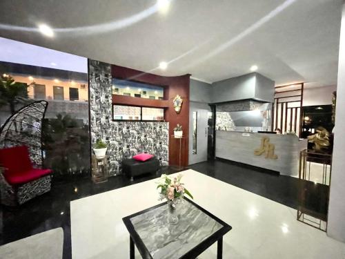 a living room with a table and red chairs at Little Rock Cebu in Mactan