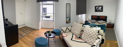 a living room with a couch and a table at Historical Center Apartments in Ponta Delgada