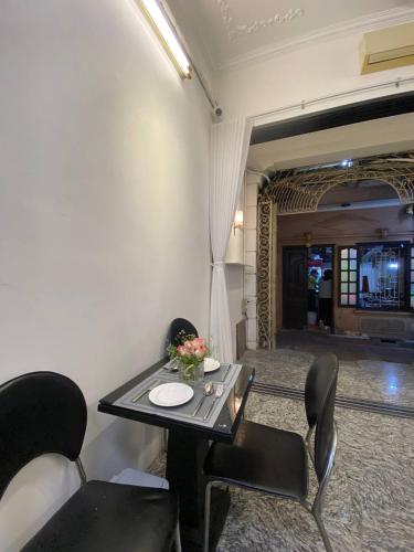 a room with a table and chairs and a hallway at Okaeri Homestay in Hanoi
