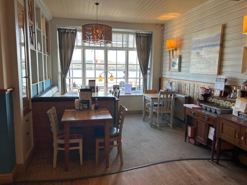 a kitchen with a table and chairs and a dining room at Hotel Penwig in New Quay