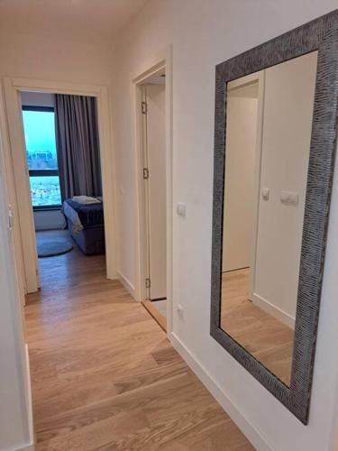 a mirror on a wall in a room with a hallway at MarijaN Belgrade Waterfront in Sajmište