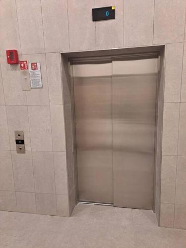a metal elevator door in a building at MarijaN Belgrade Waterfront in Sajmište
