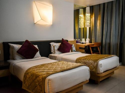 מיטה או מיטות בחדר ב-Nexstay Asma Tower