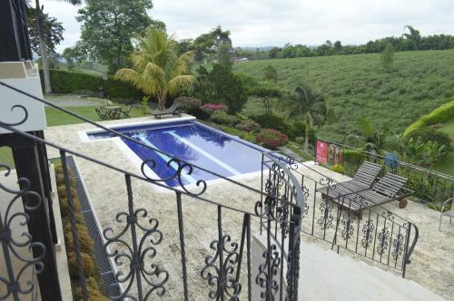 a swimming pool on the balcony of a house at Hotel Campestre la Navarra in La Suiza