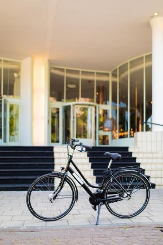 a bike parked in front of a building at Gooiland Hotel in Hilversum