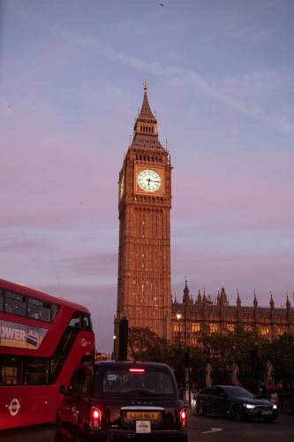 a clock tower in london with big ben in the background at The Tophams Hotel in London