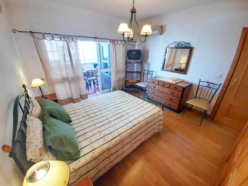 a bedroom with a bed and a dresser and a mirror at Cascais - Localização AC Parking Lift in Cascais