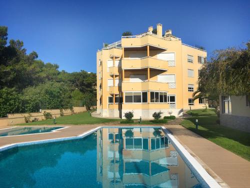 a building with a swimming pool in front of a building at Cascais - Localização AC Parking Lift in Cascais