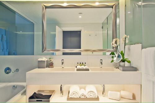a bathroom with two sinks and a large mirror at InterContinental Cascais-Estoril, an IHG Hotel in Estoril