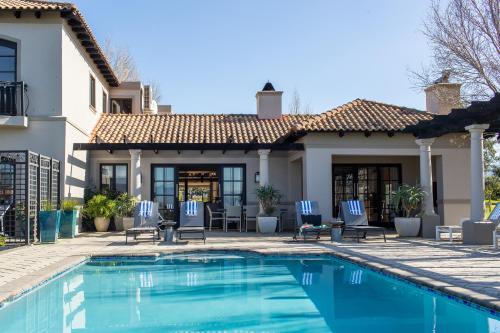 a house with a swimming pool in front of a house at Santé Wellness Retreat & Spa in Paarl
