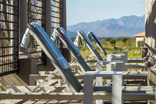 a row of lounge chairs sitting on a patio at Santé Wellness Retreat & Spa in Paarl