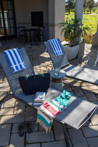 two chairs and a table with towels on it at Santé Wellness Retreat & Spa in Paarl