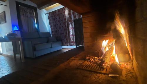 a fireplace in a living room with flames in it at Happy Home Hosting in Rieti