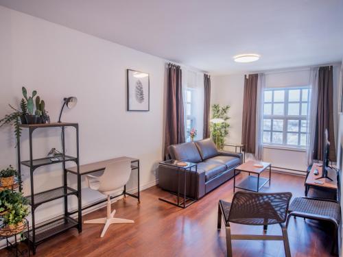 a living room with a couch and a table at Les résidences touristiques Victoria in La Baie