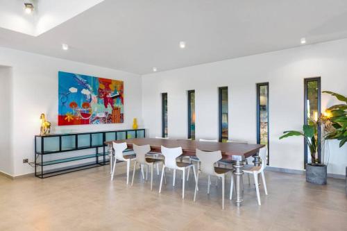 a dining room with a table and chairs at Slowlife Wellness Villa! in Baie Longue