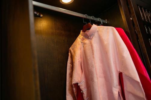 a shirt hanging on a rack in a closet at Nostalgia Halong Cruise in Ha Long